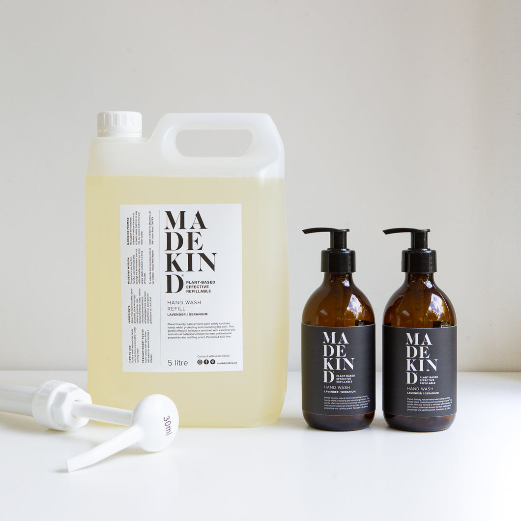 Photo of full 5 litre hand wash refill with two empty amber glass lavender and geranium hand wash or hand lotion bottles with a large pump to the side.