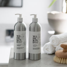 Load image into Gallery viewer, Photo of MadeKind&#39;s natural shampoo and conditioner in aluminium bottles in a bathroom
